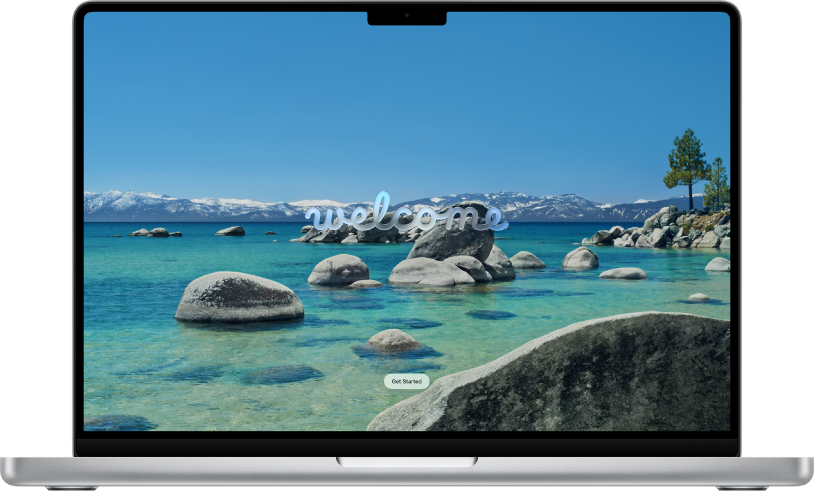 Egy Mac képernyője egy tavat és hegyeket ábrázoló háttérképpel, és egy, a felhasználókat a macOS Tahoe használatának megkezdésére buzdító üzenettel.