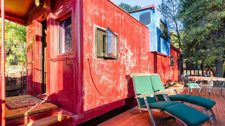 A colorful caboose with mountain views in Cornell