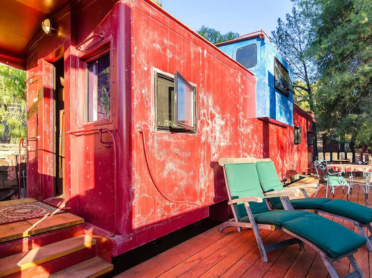 A colorful caboose with mountain views in Cornell