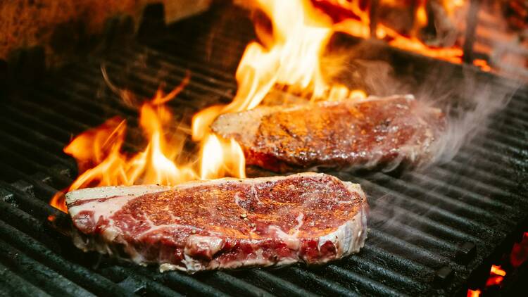 Two steaks cooking at Alfie's