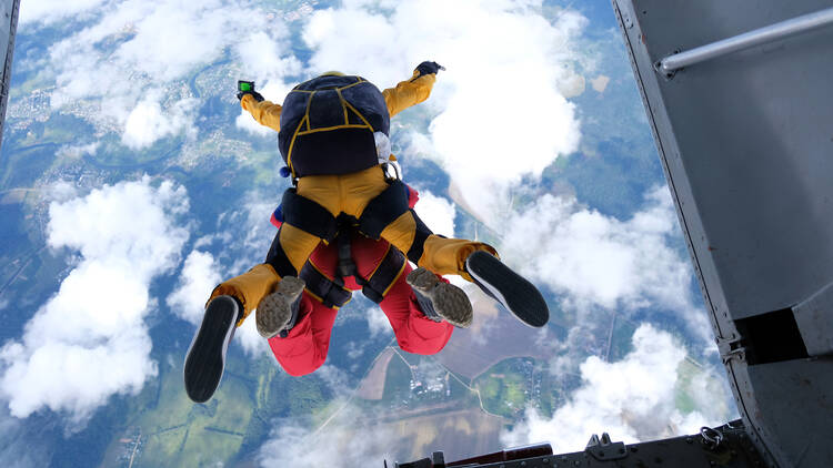 Tandem skydivers jumping out of a plane