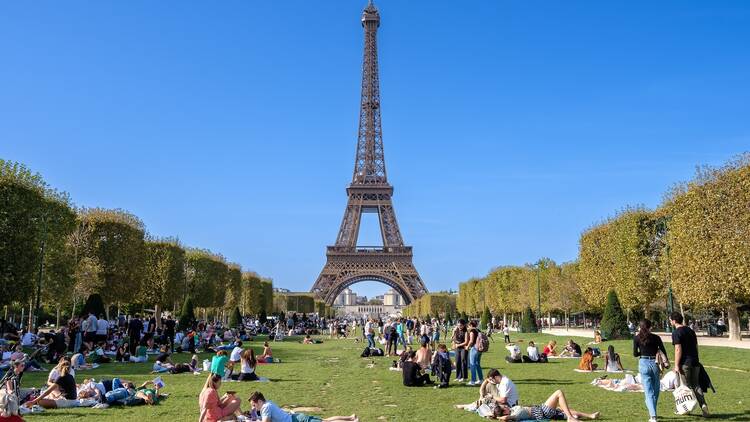 Panoramic view of the Champ de Mars, Field of Mars, a large public greenspace with people in Paris France