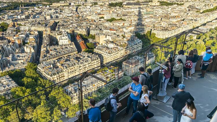 tourists visiting the second floor of the Eiffel Tower in Paris, France