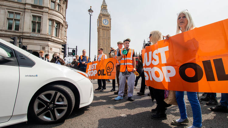 Just Stop oil activists holding up a sign